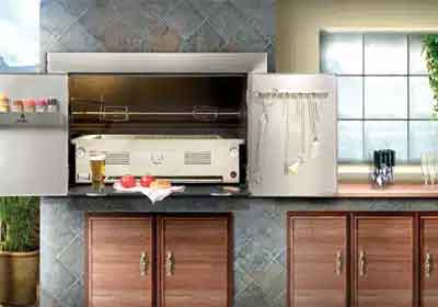 Built-in stainless steel cooker with rotisserie spit in a slate tiled wall above timber cabinetry