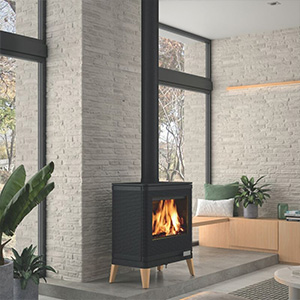 Contemporary wood-burning stove with glass door and wooden legs in modern living room.