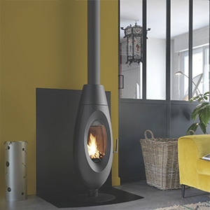 Contemporary oval wood-burning stove with pedestal base in modern living room interior.
